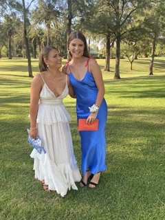White flowy tiered maxi dress with shoestring straps.