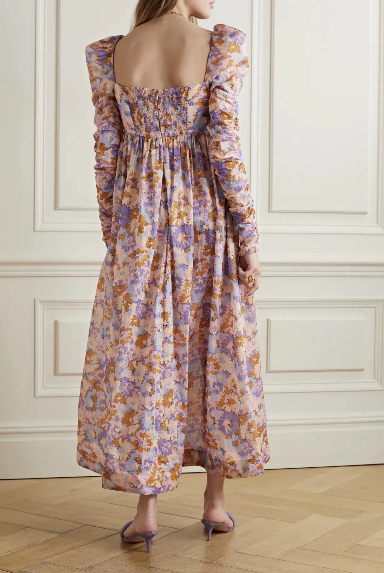 Zimmermann's dress is printed with abstract florals in warm, colorful hues. Made from lightweight cotton-voile, it has a sweetheart neckline framed by lightly puffed shoulders and a gathered empire waist. The ruched sleeves add to the feminine feel.