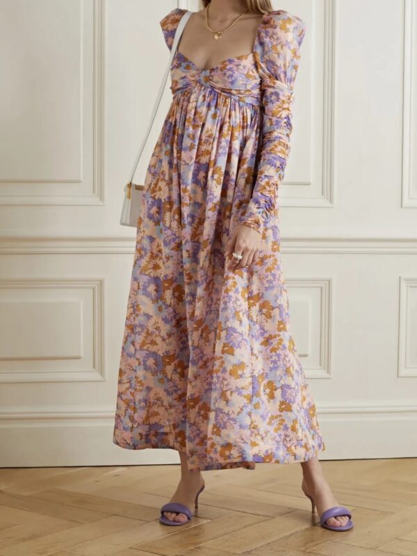 Zimmermann's dress is printed with abstract florals in warm, colorful hues. Made from lightweight cotton-voile, it has a sweetheart neckline framed by lightly puffed shoulders and a gathered empire waist. The ruched sleeves add to the feminine feel.