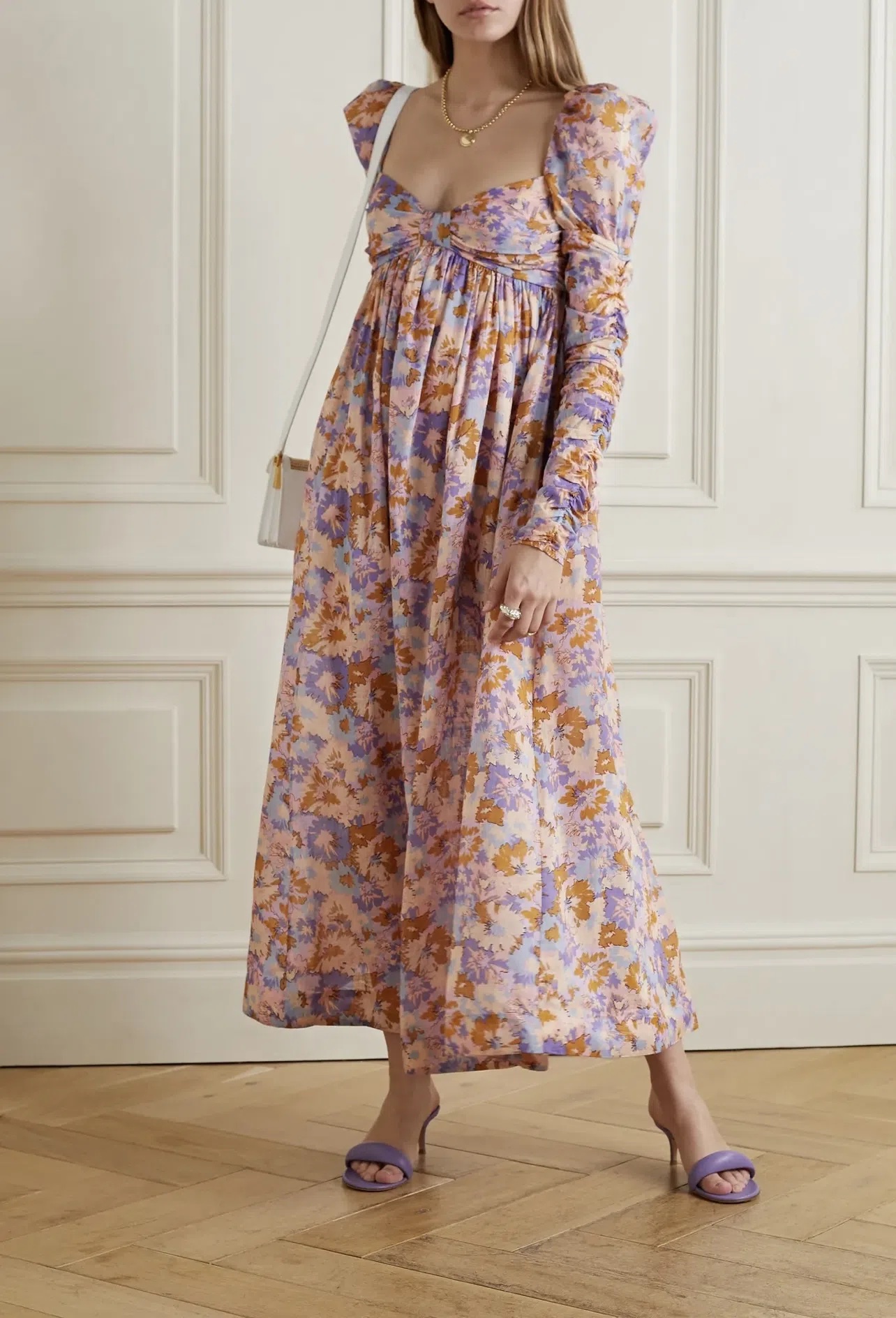 Zimmermann's dress is printed with abstract florals in warm, colorful hues. Made from lightweight cotton-voile, it has a sweetheart neckline framed by lightly puffed shoulders and a gathered empire waist. The ruched sleeves add to the feminine feel.