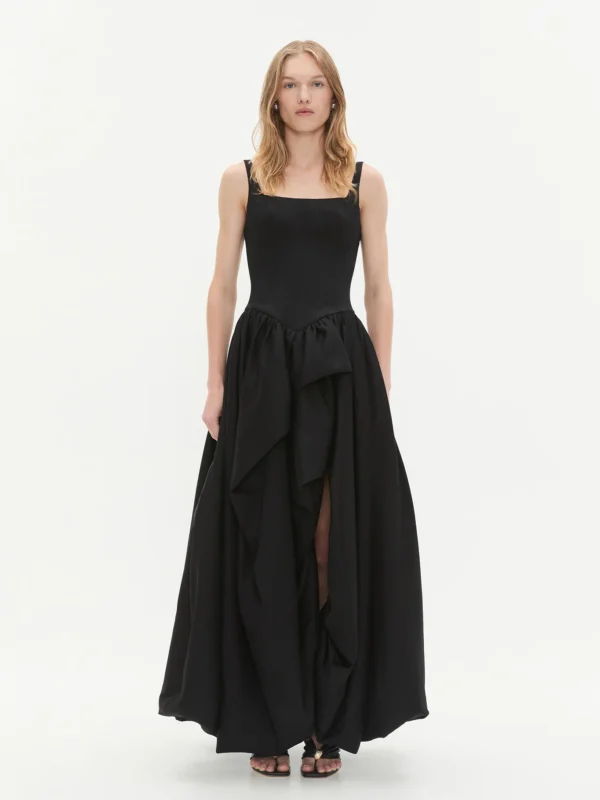 An ankle length a-line black gown with flounces and a slit
